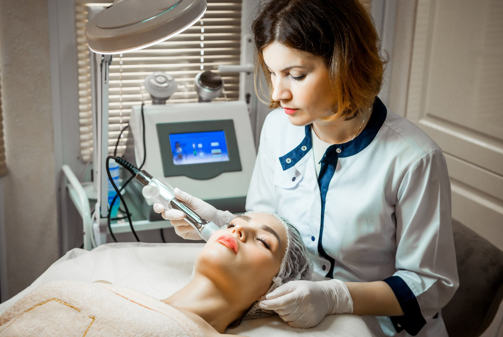Aesthetician performing a hydrafacial treatment at a Scarborough med spa, helping clients restore healthy skin and peace of mind.