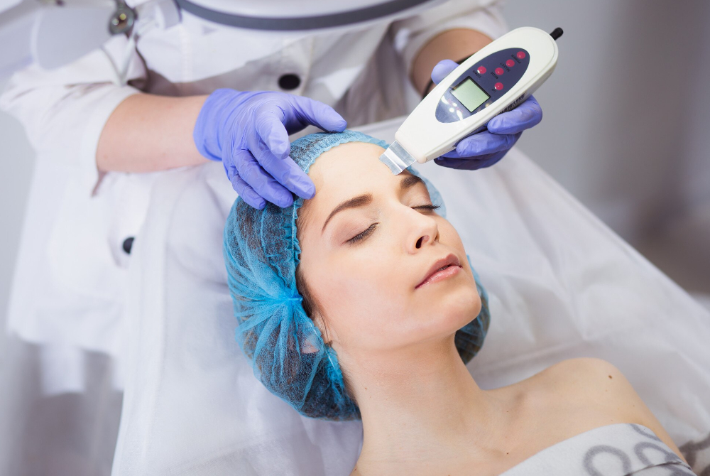 A skincare professional performing a gentle skin assessment at a Scarborough med spa, promoting wellness beyond appearance and encouraging self-care.