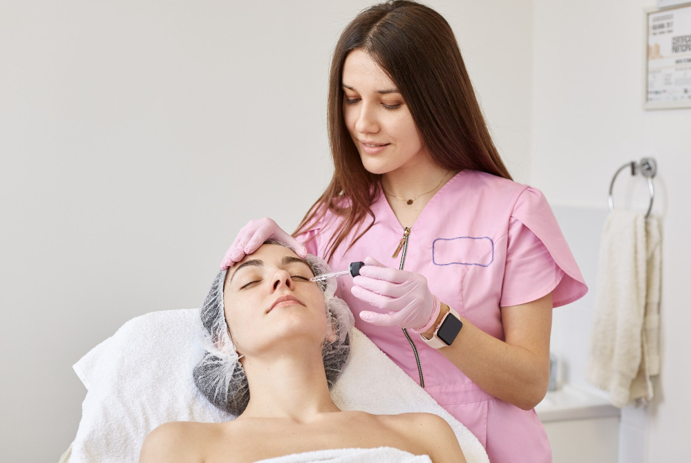 Aesthetician checking a client’s skin before treatment.