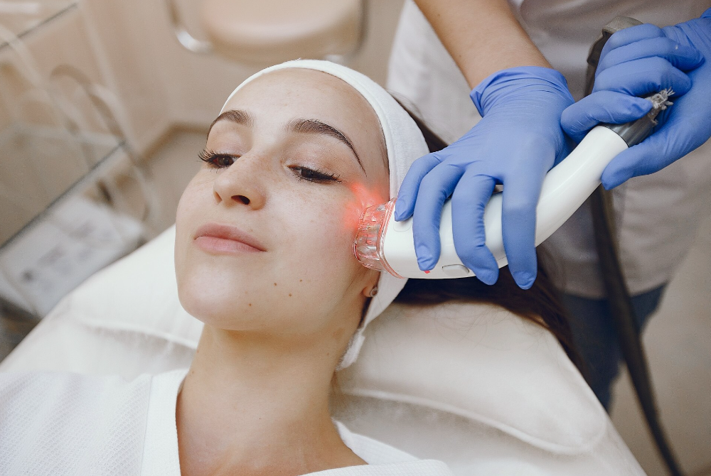 Light-based laser treatment being applied to improve uneven skin tone