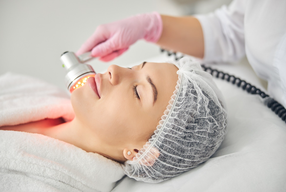 Light-based laser treatment being applied to improve uneven skin tone
